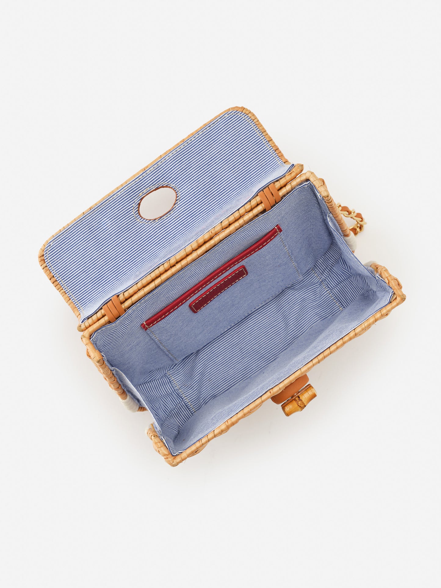 Open Waverly Wicker Handbag by J.McLaughlin displaying its striped blue interior lining and leather trim, showcasing effortlessly stylish design and enduring craftsmanship.
