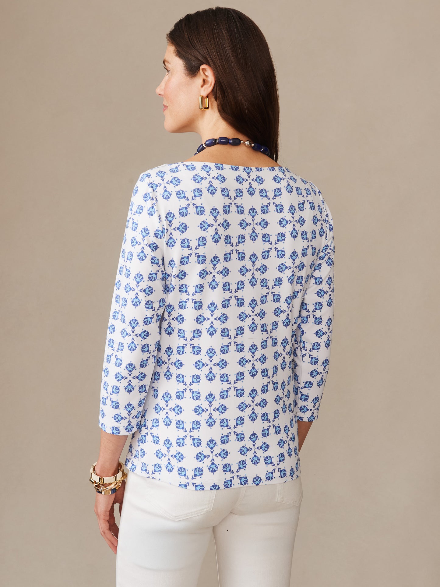Woman wearing the Wavesong Tee in Mythic Tile by J.McLaughlin, featuring a classic blue and white pattern, effortlessly stylish with enduring designs and innovative fabrics.
