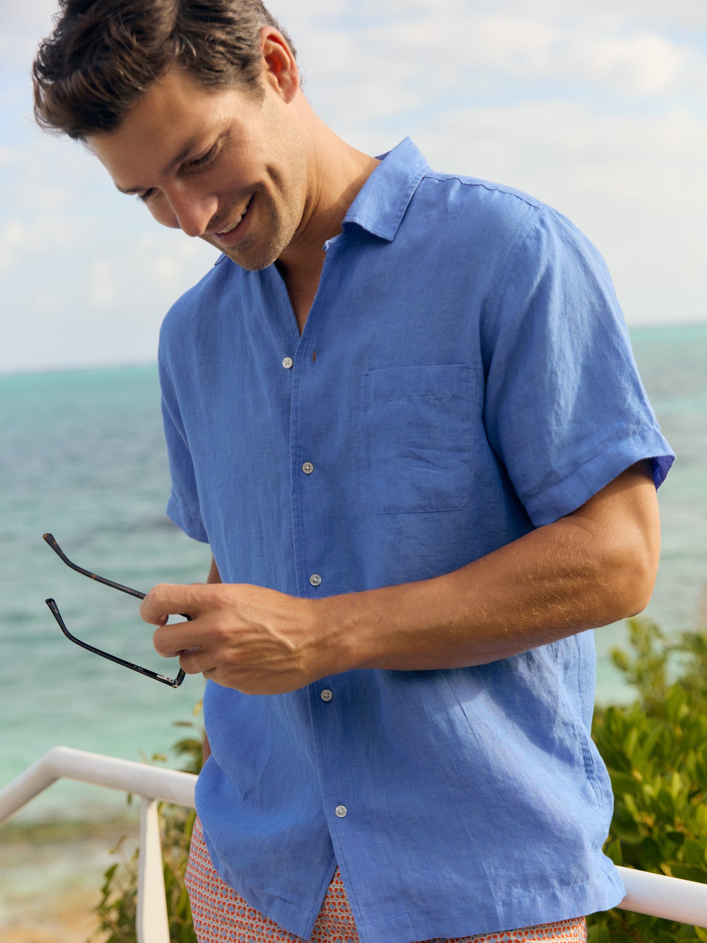 Model wearing J.McLaughlin Irons linen shirt in french blue made with linen.