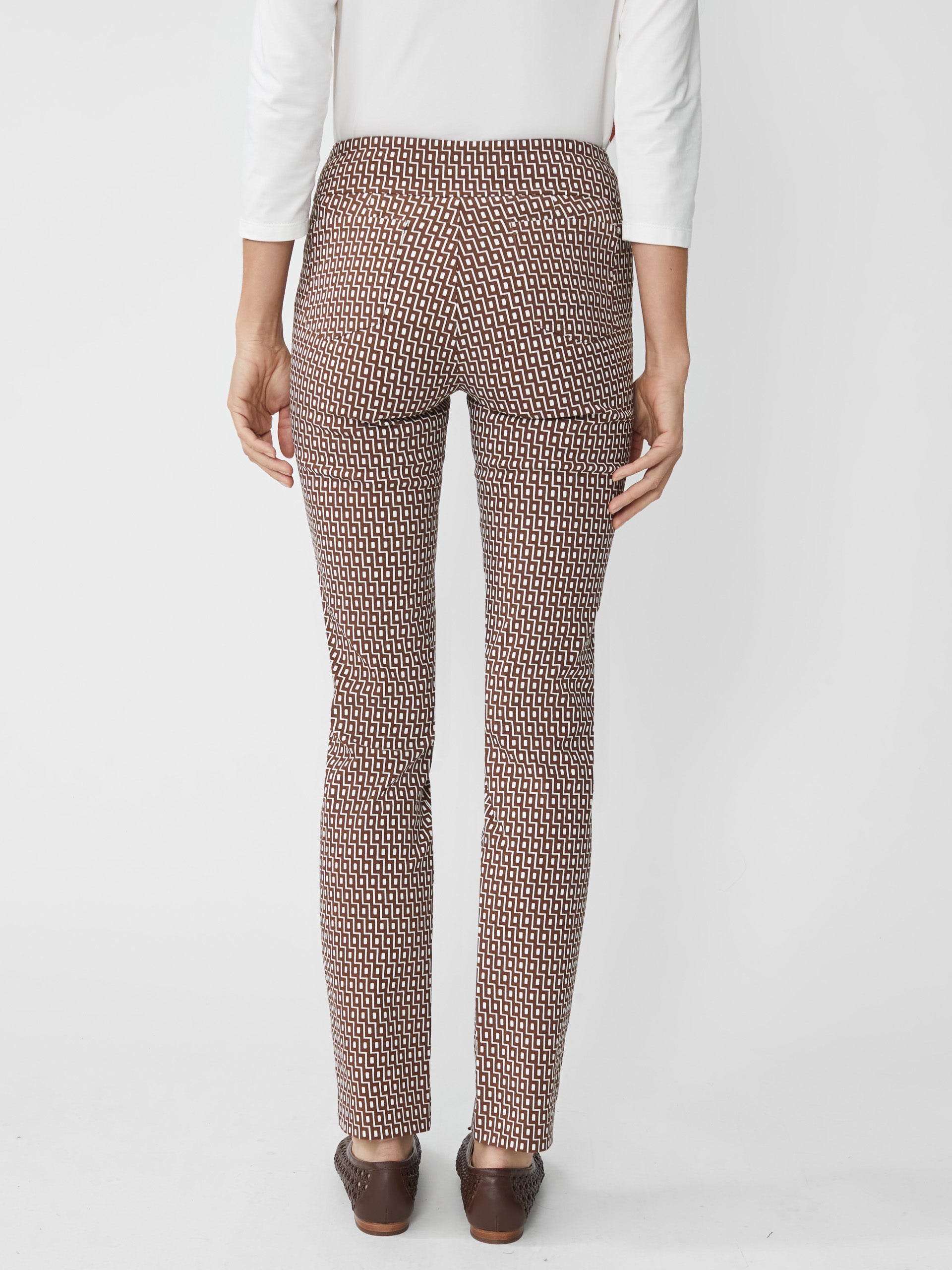 Back view of a woman wearing J.McLaughlin Masie Pants in Micro City Windows featuring an innovative geometric pattern, combining effortlessly stylish design with enduring fabrics.