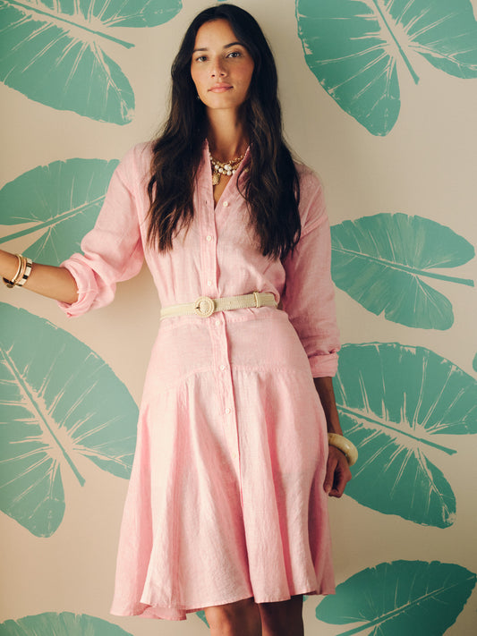 A model wearing the Mary Linen Dress in Stripe by J.McLaughlin, styled with a belt and accessories, embodying effortlessly stylish, enduring designs and innovative fabrics for a destination for defining style. Life, Well-Lived.