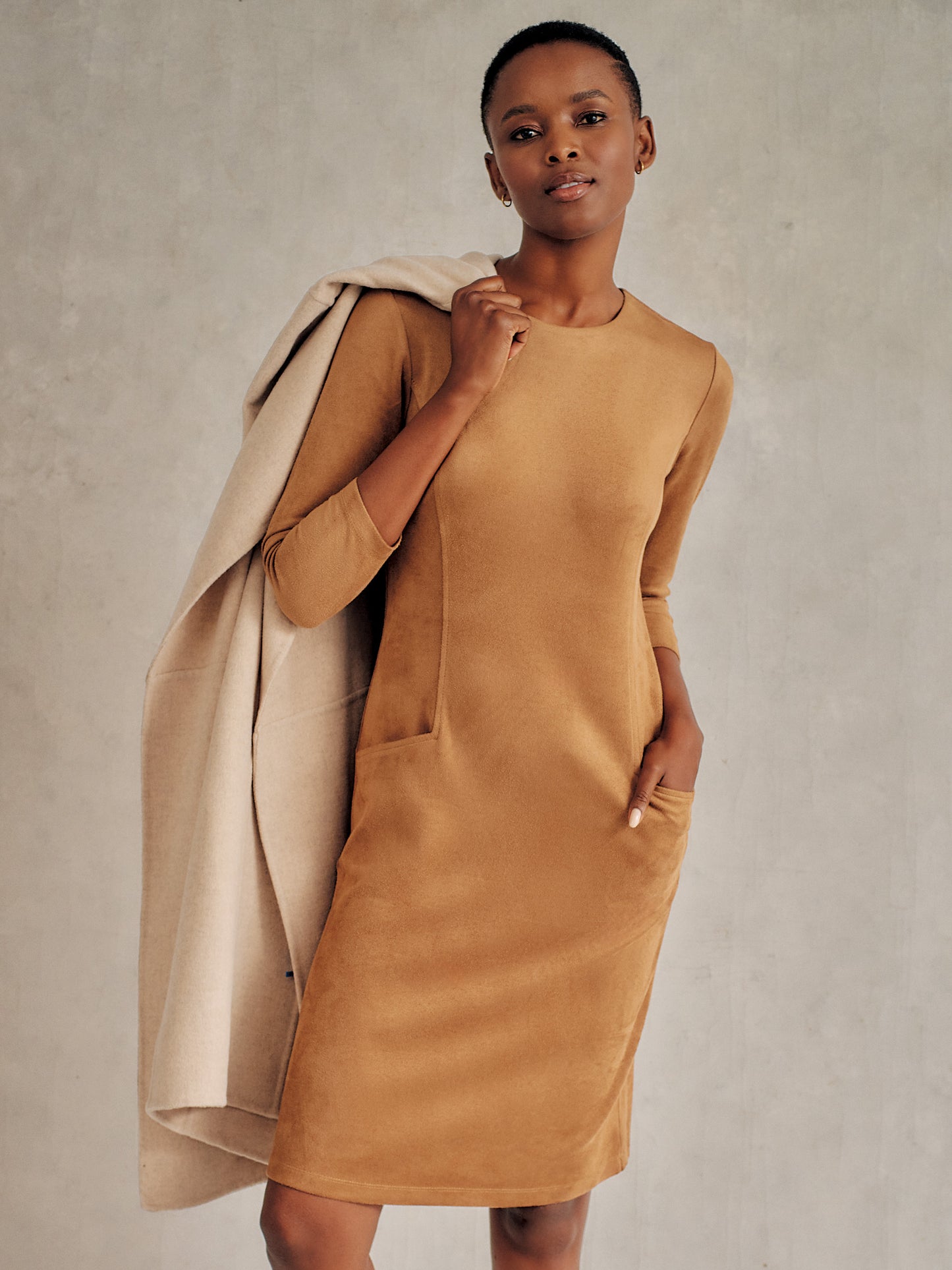 Model wearing J.McLaughlin Catalyst dress in tan made with faux suede.