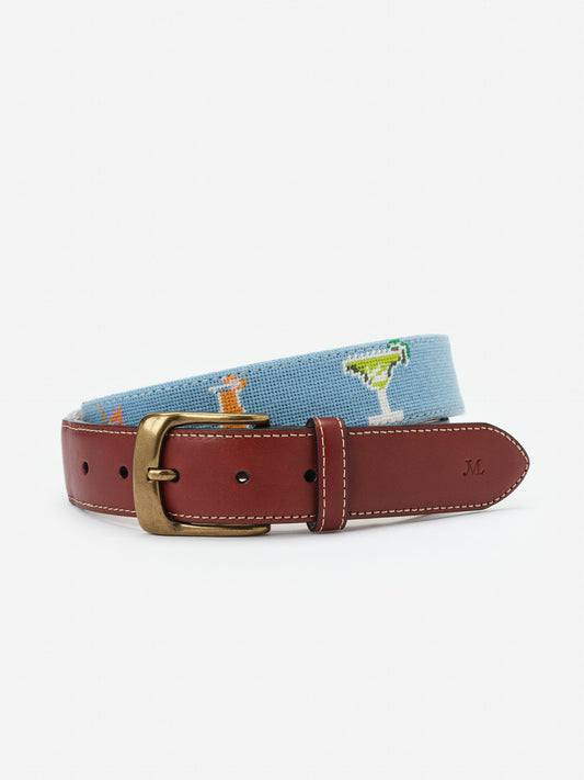 Needlepoint Belt in Cocktail Party by J.McLaughlin features a classic leather buckle and playful cocktail-themed needlepoint design, showcasing effortlessly stylish, enduring designs and a legacy of timeless fashion. A destination for defining style. Life, Well-Lived.
