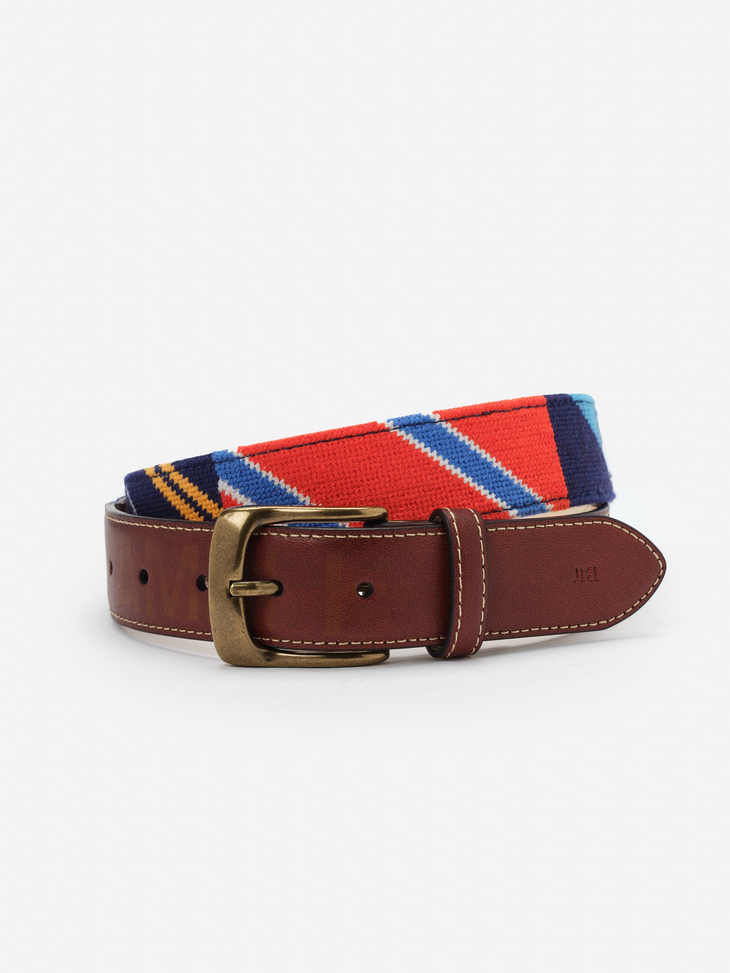 Needlepoint Belt in Stripe by J.McLaughlin featuring a colorful striped needlepoint design with a brown leather buckle strap, combining timeless style and quality craftsmanship.