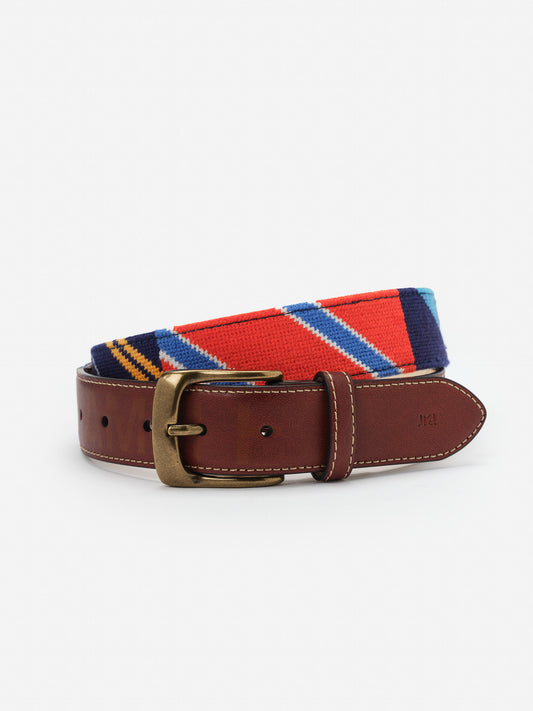 Needlepoint Belt in Stripe by J.McLaughlin featuring a colorful striped needlepoint design with a brown leather buckle strap, combining timeless style and quality craftsmanship.
