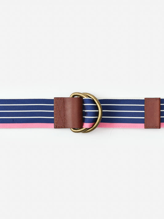 Ribbon Belt in Stripe by J.McLaughlin features enduring designs with navy and pink stripes, leather accents, and brass rings, reflecting a legacy of timeless fashion and effortless style.