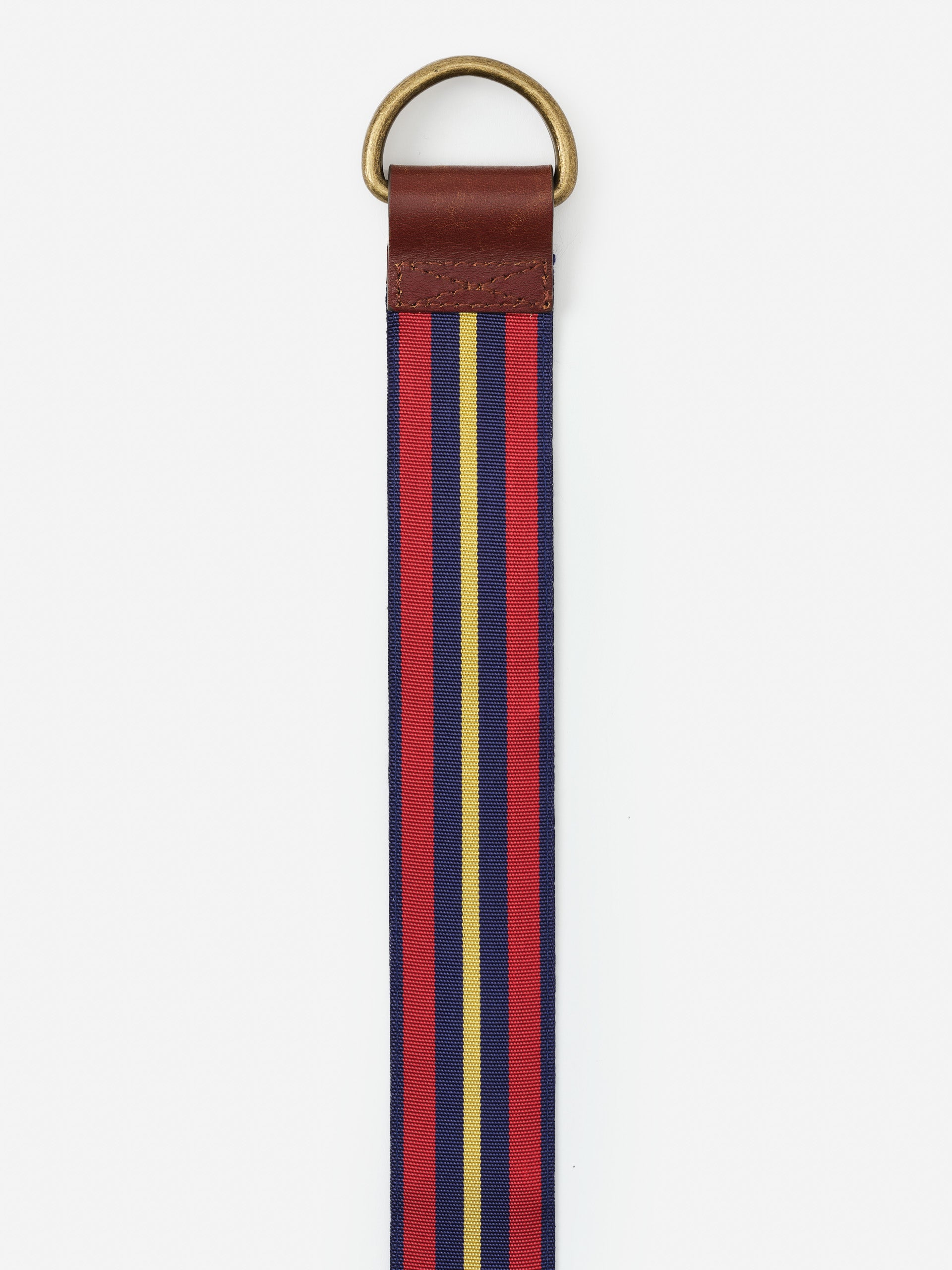Ribbon Belt in Stripe by J.McLaughlin features an effortlessly stylish striped fabric with a leather accent and brass ring, combining enduring designs and a legacy of timeless fashion.