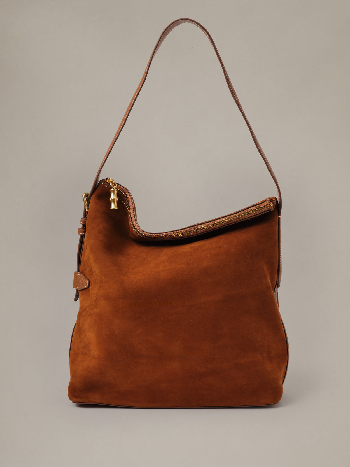 The Montecito Suede Hobo Bag by J.McLaughlin in rich brown suede with a long shoulder strap and zip top for relaxed everyday style