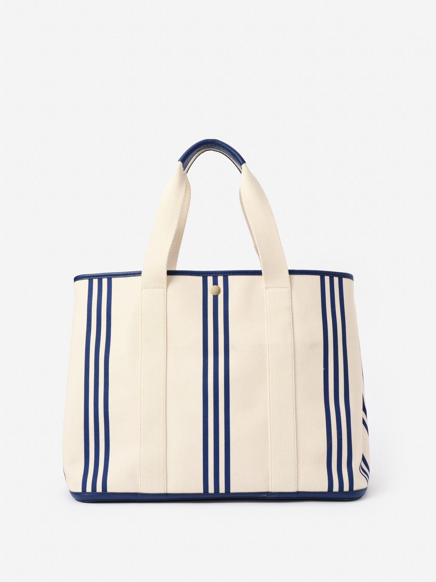 Alma Canvas Tote in Stripe by J.McLaughlin features classic navy stripes on durable canvas, combining effortlessly stylish design with enduring quality for a legacy of timeless fashion.