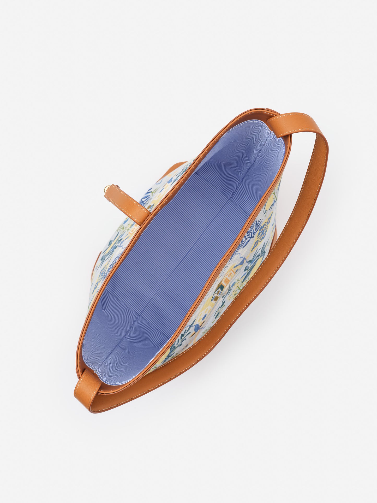 Top view of the Crawford Handbag in Amalfi Coast by J.McLaughlin, featuring a vibrant floral pattern, tan leather trim, and a spacious blue interior, effortlessly stylish and enduring.