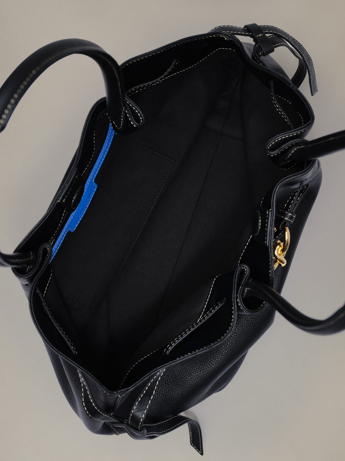 The Lex Leather Tote Bag by J.McLaughlin shown open to reveal its spacious black leather interior and polished hardware