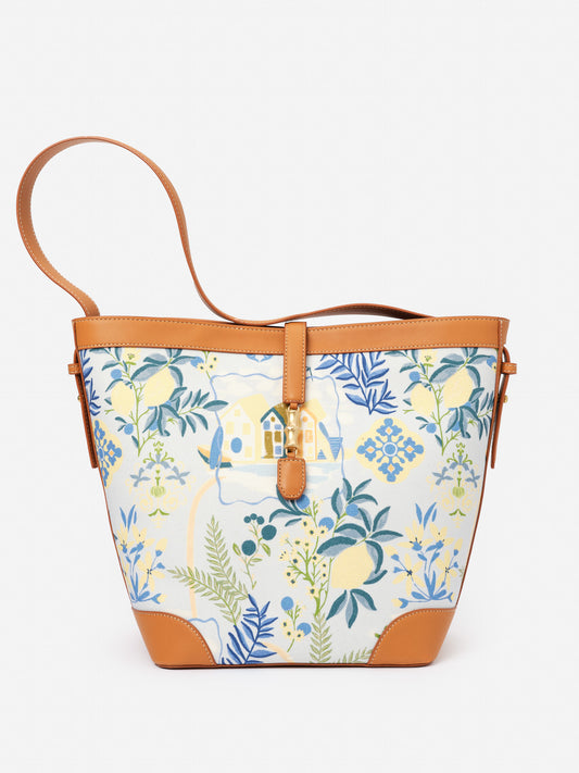 Crawford Handbag in Amalfi Coast by J.McLaughlin features a floral and seaside print with tan leather accents, embodying effortlessly stylish, enduring designs in bags at a destination for defining style. Life, Well-Lived.