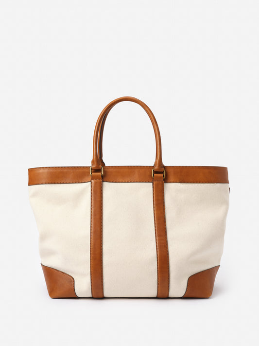 Wells Canvas Tote by J.McLaughlin featuring a classic canvas body with rich leather trim and handles, combining effortless style and enduring design for a life well-lived.