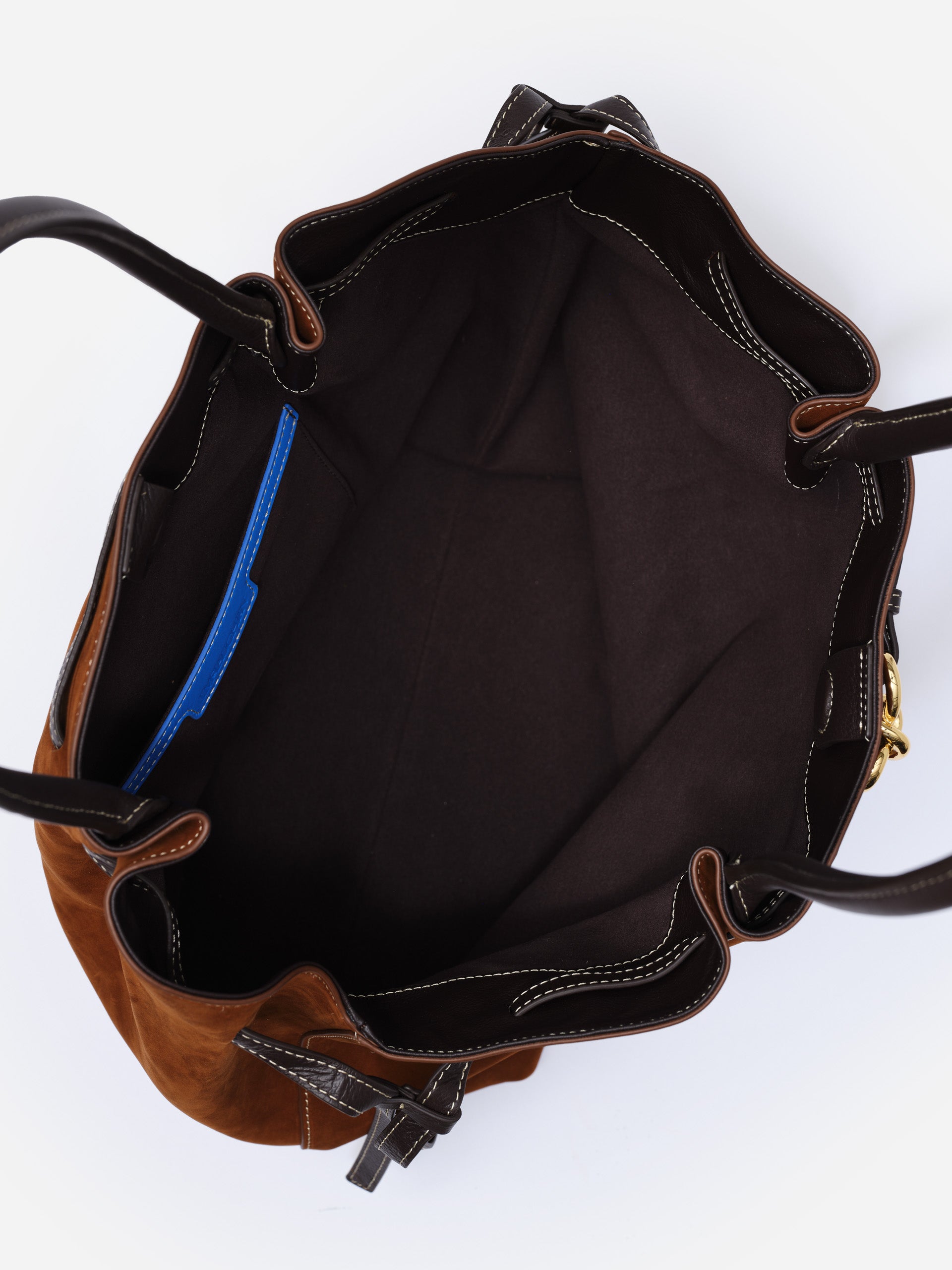 Open view of The Lex Suede Tote Bag by J.McLaughlin showing spacious interior with dark lining and contrasting stitching, highlighting craftsmanship and timeless design.