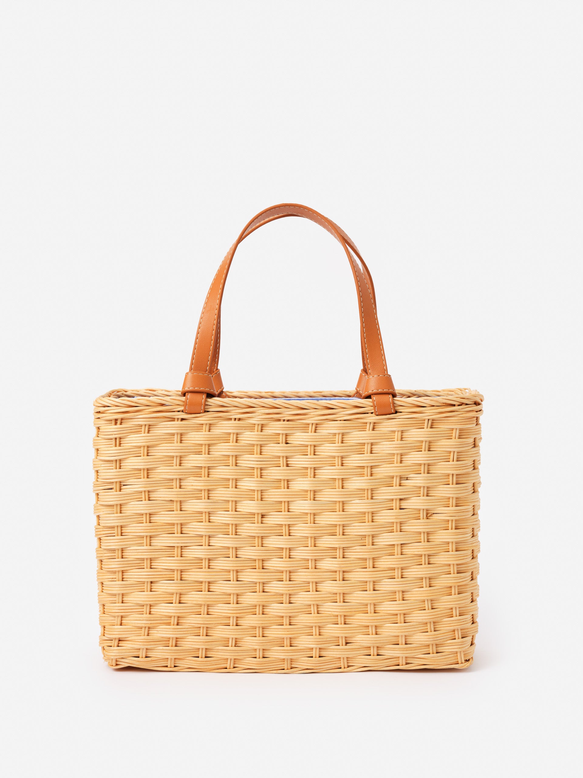 Caroline Wicker Handbag by J.McLaughlin features an effortlessly stylish woven wicker design with leather handles, blending enduring designs and innovative fabrics for a timeless accessory.