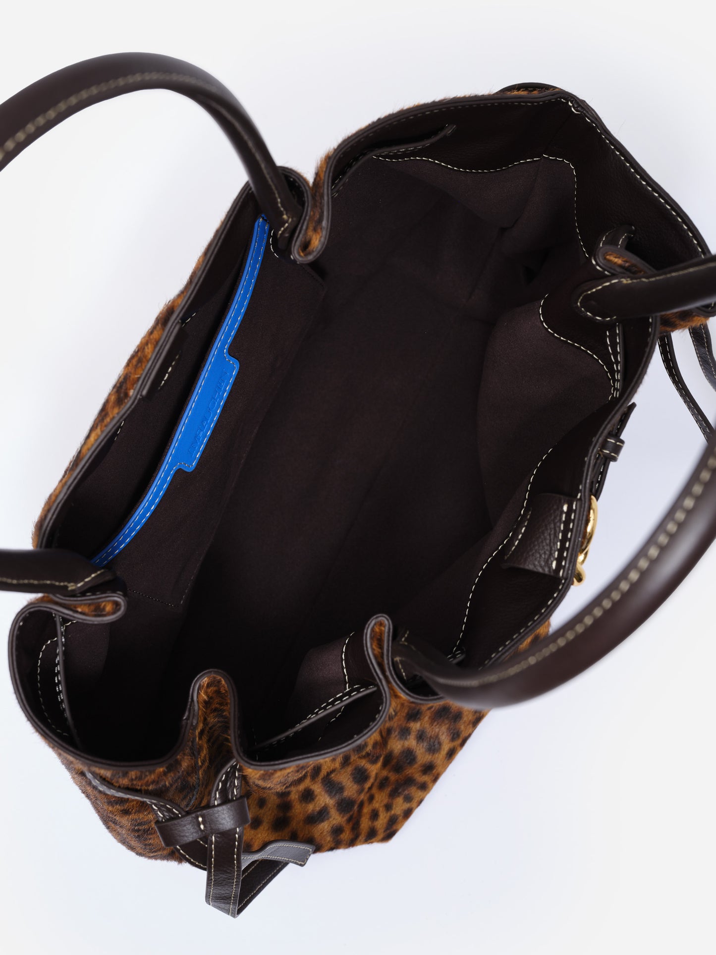 The Lex Pony Hair Tote Bag in Leopard by J.McLaughlin, open top view showing spacious interior with black lining and sturdy dark brown handles, combining style and craftsmanship.