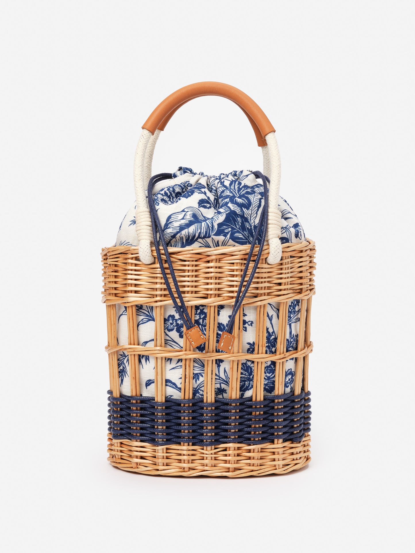 Caryl Wicker Handbag in Giardino Toile from J.McLaughlin, featuring woven wicker with navy and white toile fabric, effortlessly stylish for enduring designs and timeless fashion.