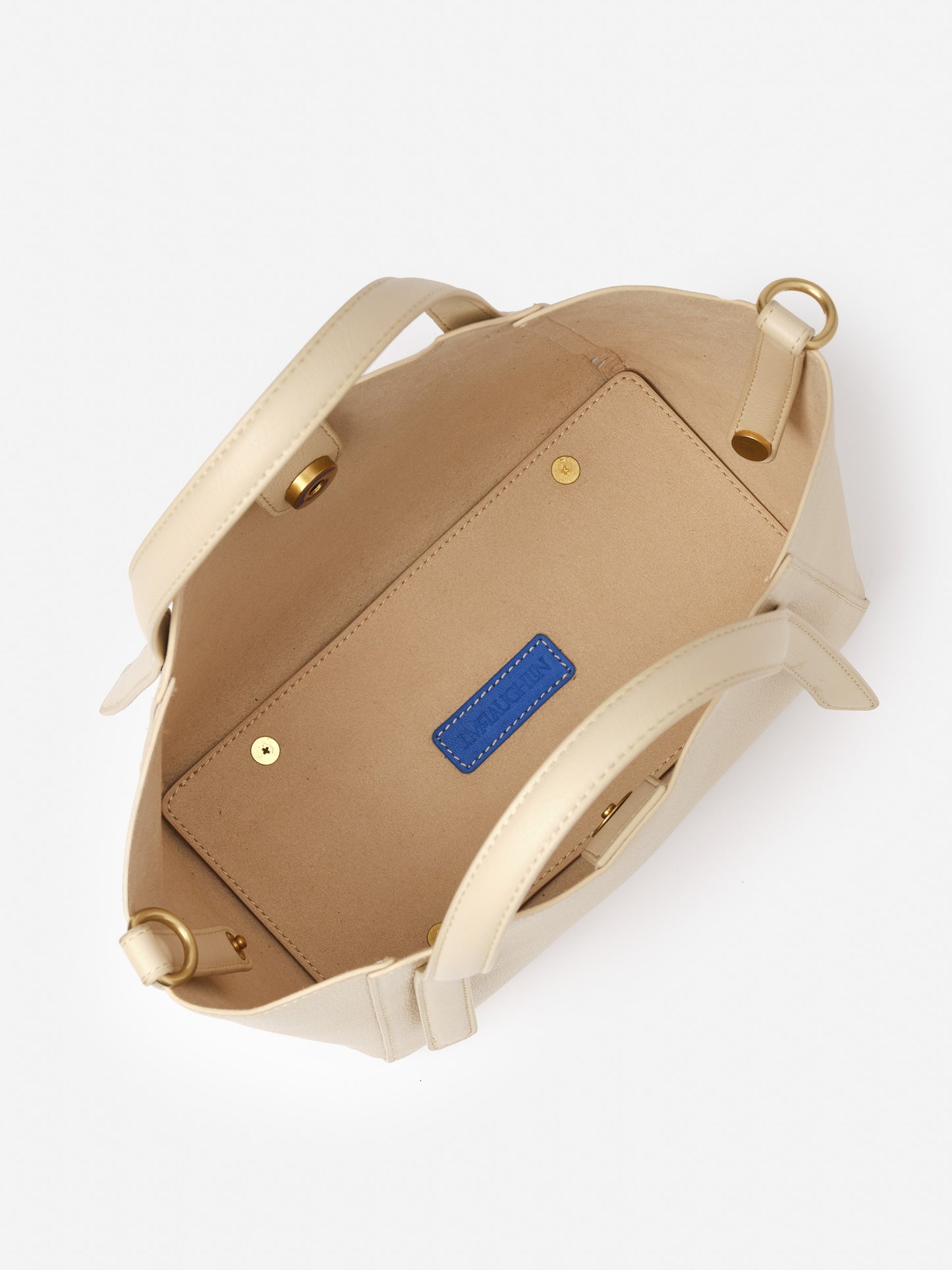 Interior view of the Lane Leather Mini Tote by J.McLaughlin in a light neutral tone, showcasing refined craftsmanship and timeless design for an effortlessly stylish accessory.