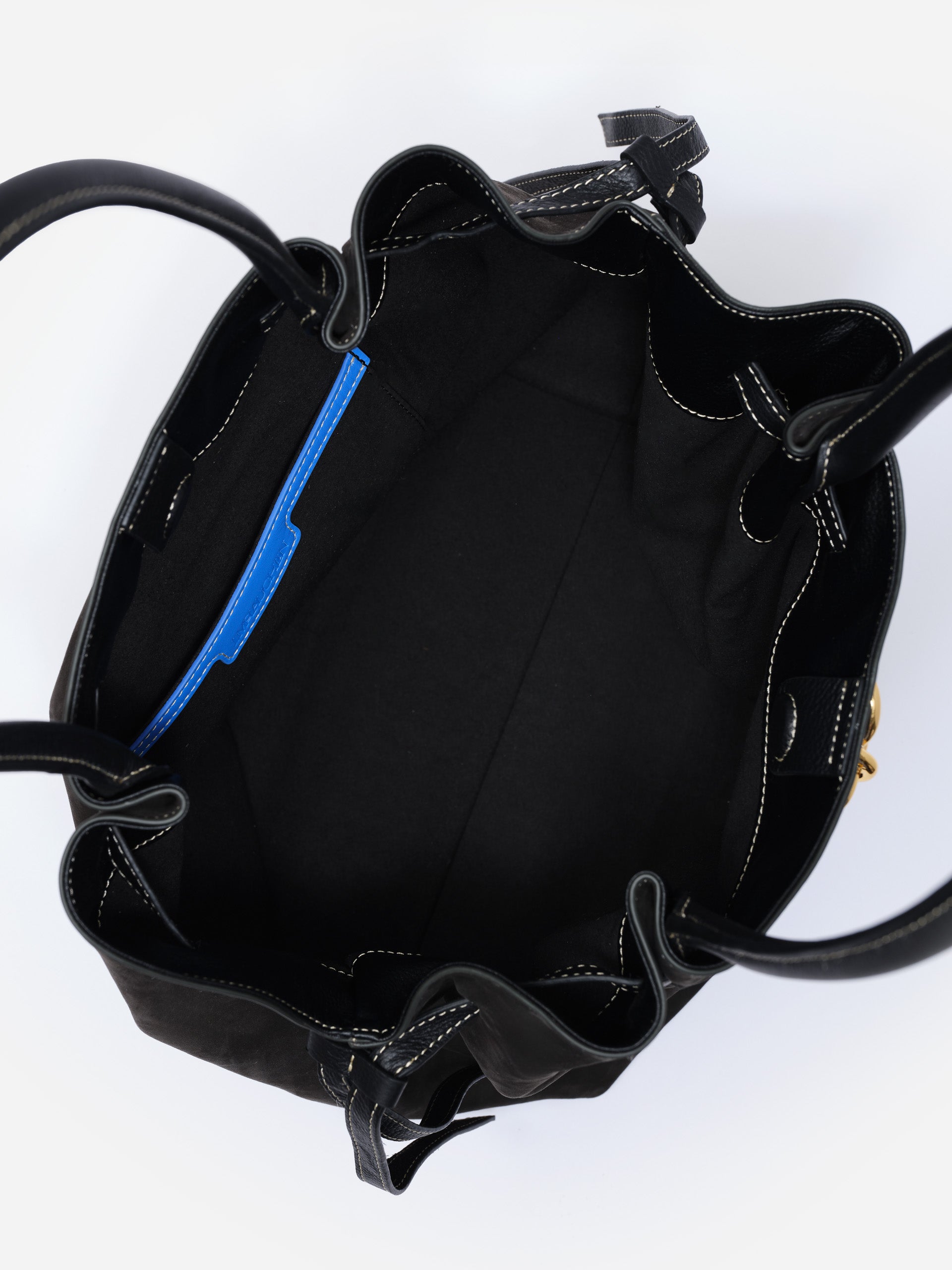 Inside view of The Lex Suede Tote Bag by J.McLaughlin in black, showcasing spacious interior with sleek design and quality craftsmanship for enduring style.