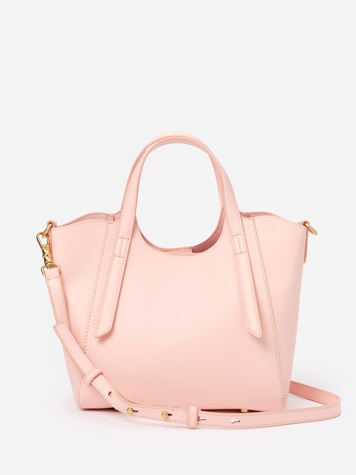Lane Leather Mini Tote by J.McLaughlin in soft pink leather, featuring a structured design with dual handles and an adjustable strap, embodying effortlessly stylish and enduring designs.