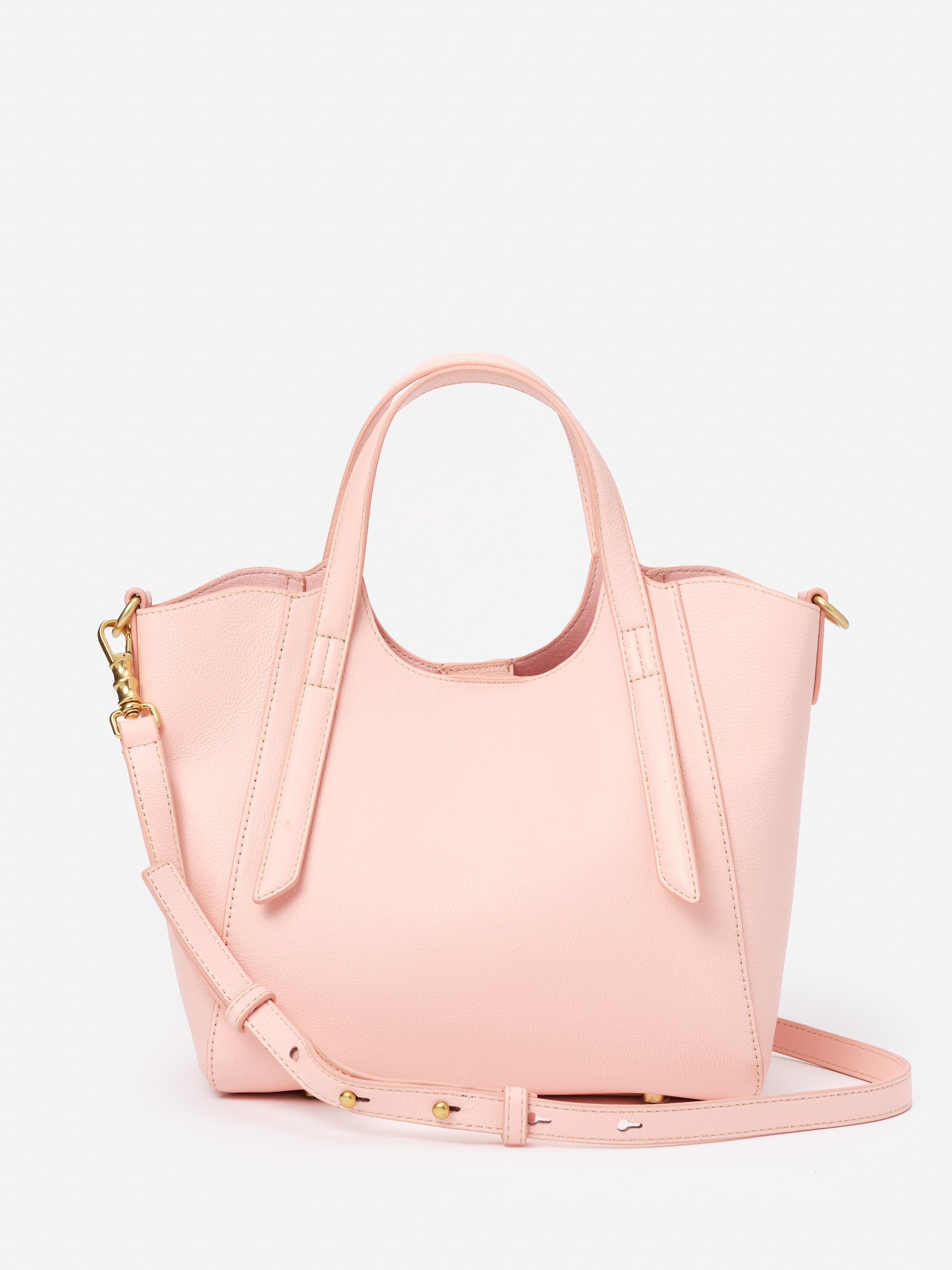 Lane Leather Mini Tote by J.McLaughlin in soft pink leather, featuring a structured design with dual handles and an adjustable strap, embodying effortlessly stylish and enduring designs.