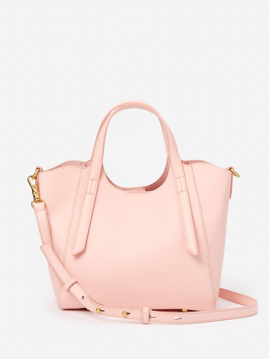 Lane Leather Mini Tote by J.McLaughlin in soft pink leather, featuring a structured design with dual handles and an adjustable strap, embodying effortlessly stylish and enduring designs.