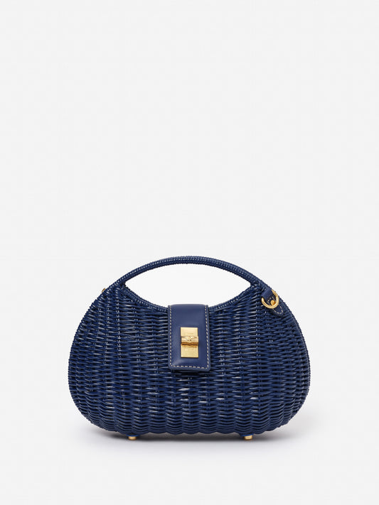 Iris Wicker Handbag by J.McLaughlin in navy blue, featuring a woven wicker design with a leather clasp and handle, showcasing effortlessly stylish, enduring designs.