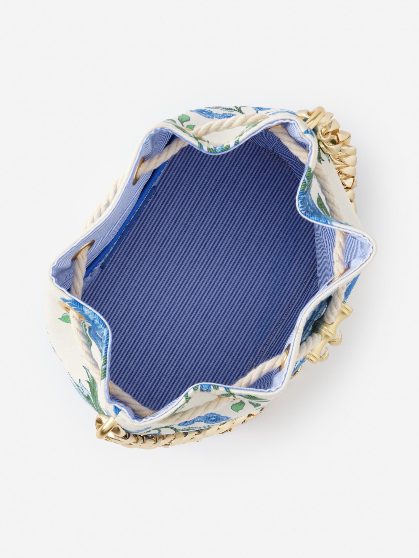 Open top view of the Daisy Bucket Bag in Mini Cerulean Garden by J.McLaughlin, showcasing its striped blue interior lining, rope drawstring closure, and classic floral exterior, perfectly blending effortless style and enduring designs from a destination for defining style, life well-lived.