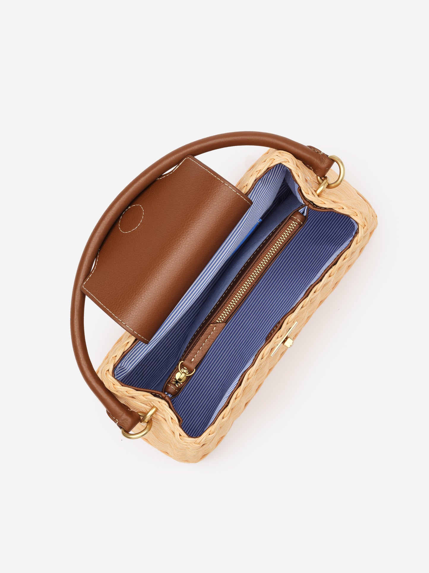 Open Faith Wicker Handbag by J.McLaughlin showcasing woven exterior, smooth brown leather flap and handle, and striped blue fabric interior with zippered pocket, effortlessly stylish and enduring design.