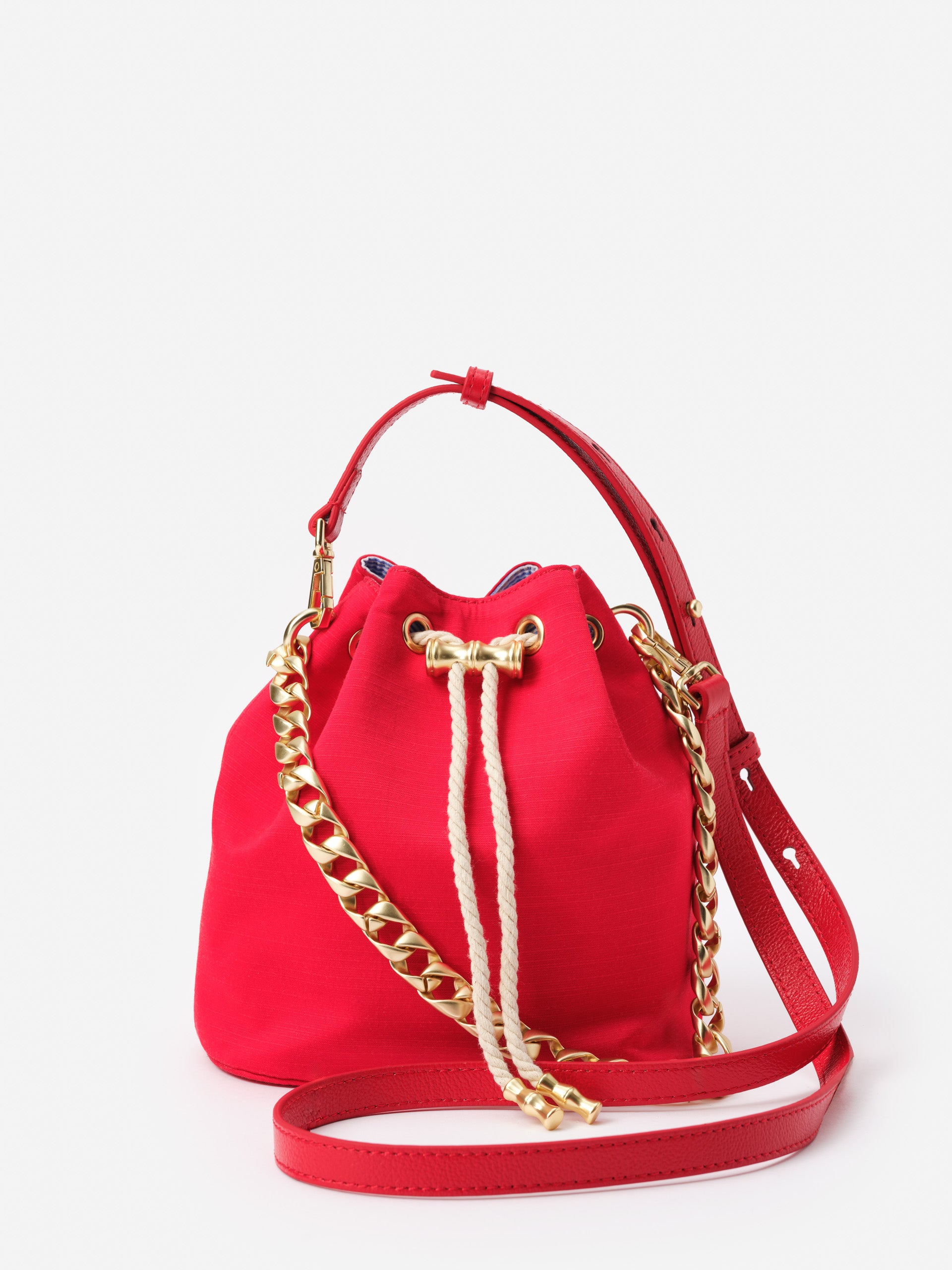 Sarah Bucket Bag by J.McLaughlin in vibrant red with a gold chain detail and adjustable strap, showcasing effortlessly stylish design and enduring craftsmanship for a life well-lived.