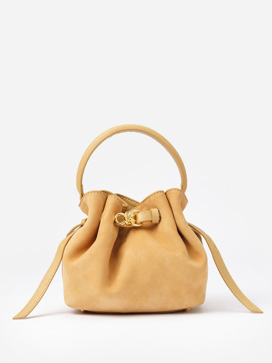 The Mini Lex Suede Handbag by J.McLaughlin in a soft tan suede, featuring a rounded handle, gold clasp detail, and an adjustable crossbody strap for versatile wear.