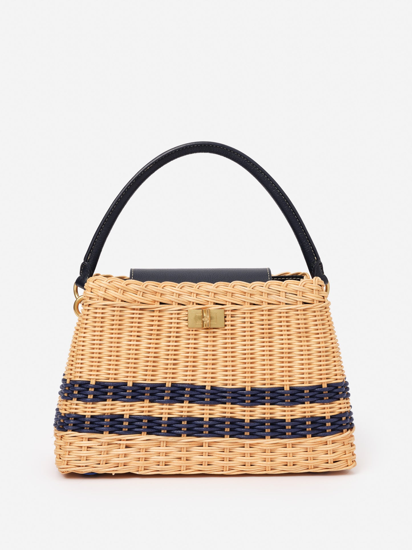 Faith Wicker Handbag by J.McLaughlin, crafted with wicker and navy detailing, offers an effortlessly stylish accessory that embodies enduring designs and timeless fashion.