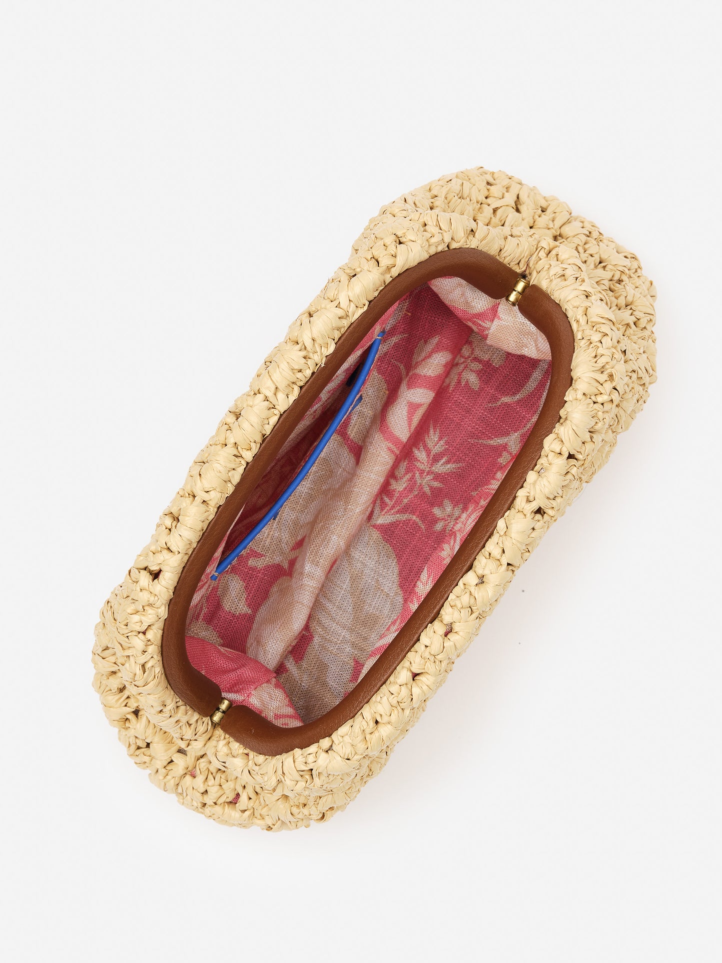 Top view of the Bambi Hand Crochet Clutch by J.McLaughlin, showcasing its cream crochet exterior and vibrant pink floral fabric interior, effortlessly stylish and enduring design.