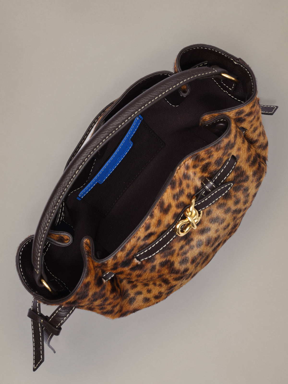The Mini Lex Pony Hair Handbag in Leopard by J.McLaughlin featuring a compact leopard print design with a top handle crossbody strap and open interior