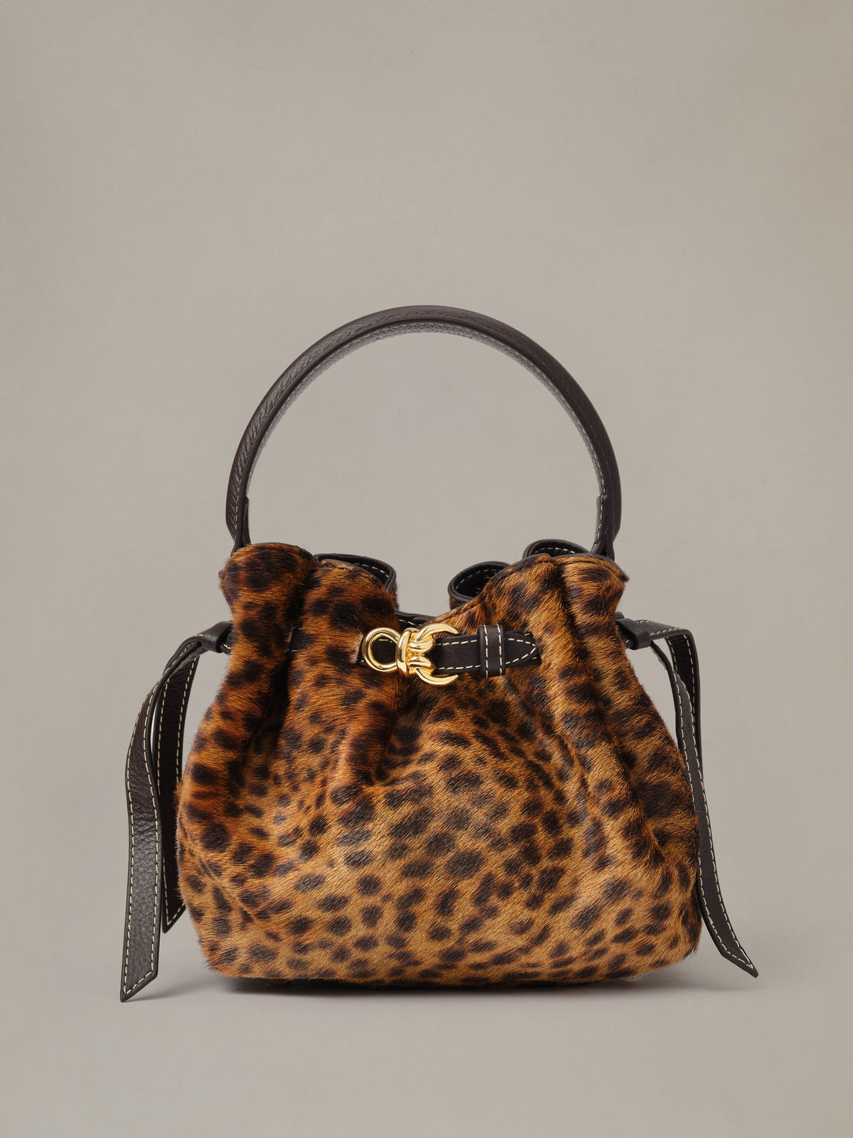 The Mini Lex Pony Hair Handbag in Leopard by J.McLaughlin with a top handle crossbody strap and gold clasp.