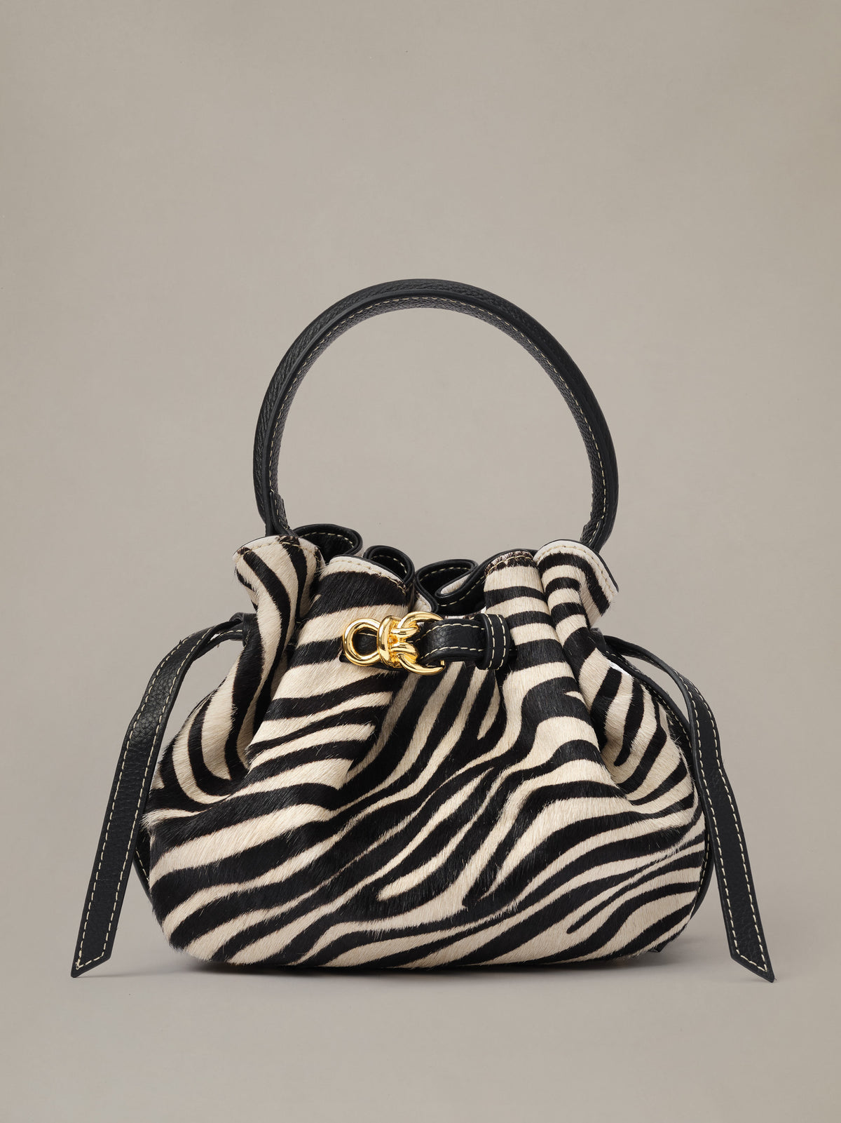 The Mini Lex Pony Hair Handbag in Zebra Stripes by J.McLaughlin with a compact zebra print design top handle drawstring closure and crossbody strap