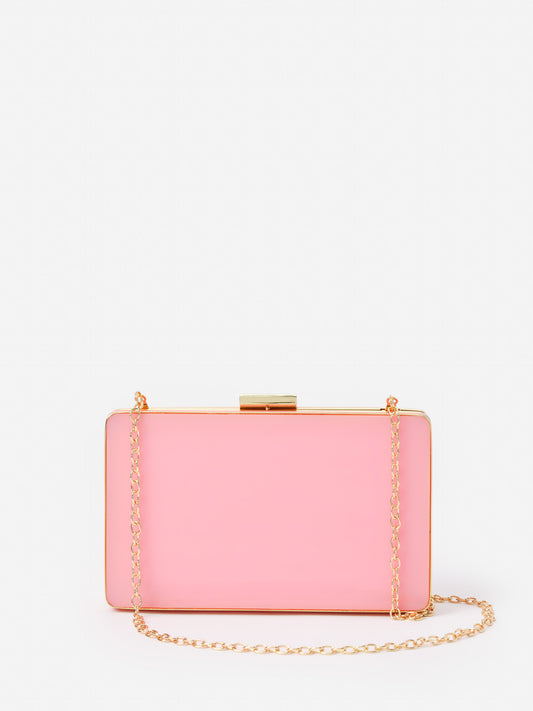 Audra Acrylic Clutch by J.McLaughlin in soft pink with a gold chain strap, showcasing effortlessly stylish elegance and enduring designs for a legacy of timeless fashion.