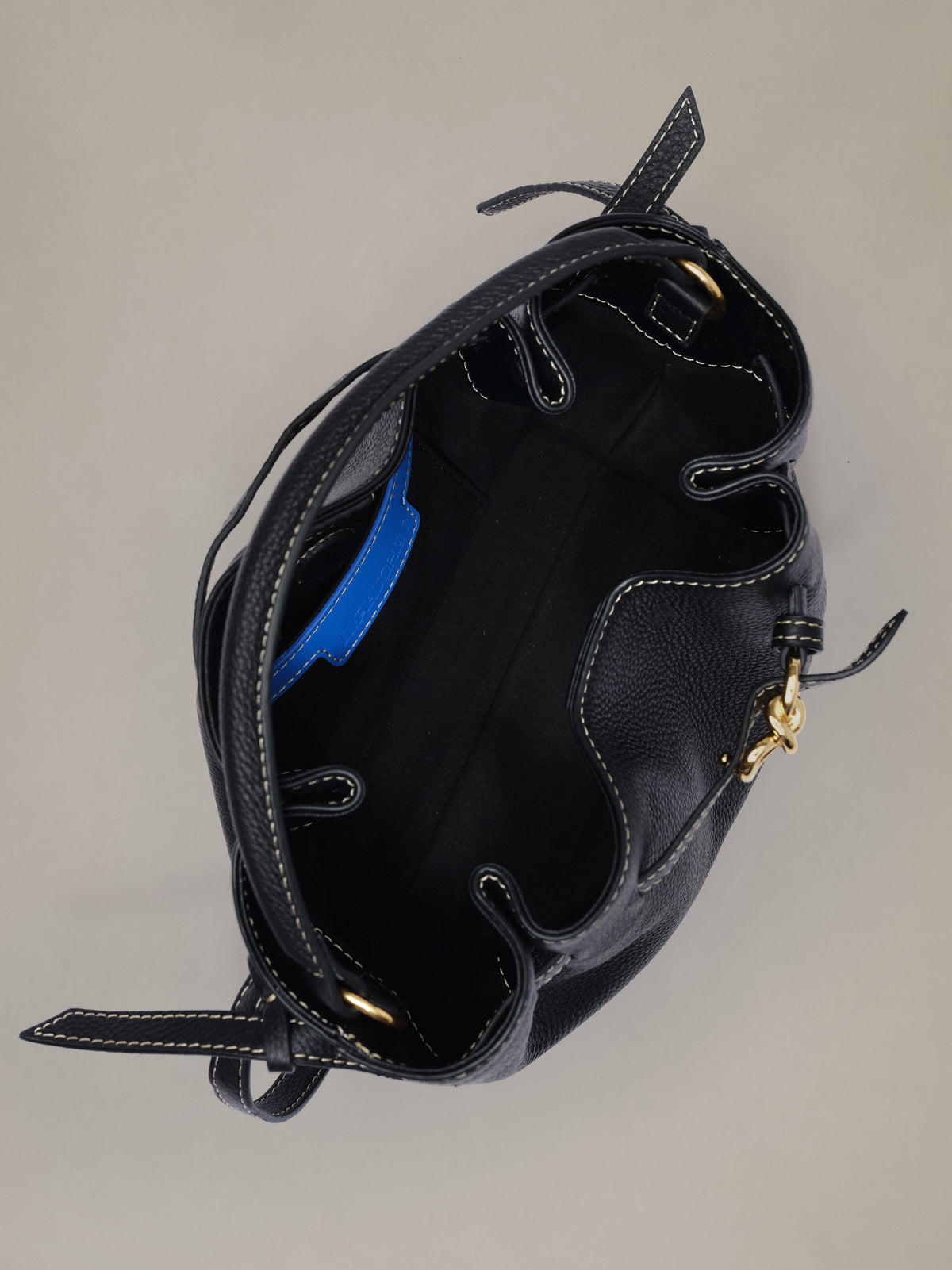 The Mini Lex Leather Handbag by J.McLaughlin in black leather with an open interior and adjustable straps for versatile hand held or crossbody wear