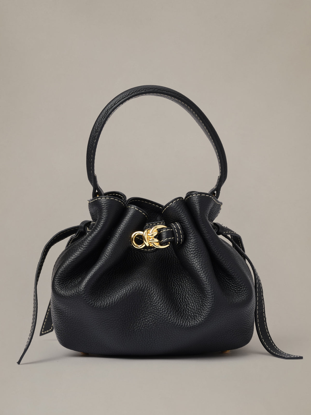 The Mini Lex Leather Handbag by J.McLaughlin in black pebbled leather with a top handle drawstring closure gold hardware and a versatile crossbody strap