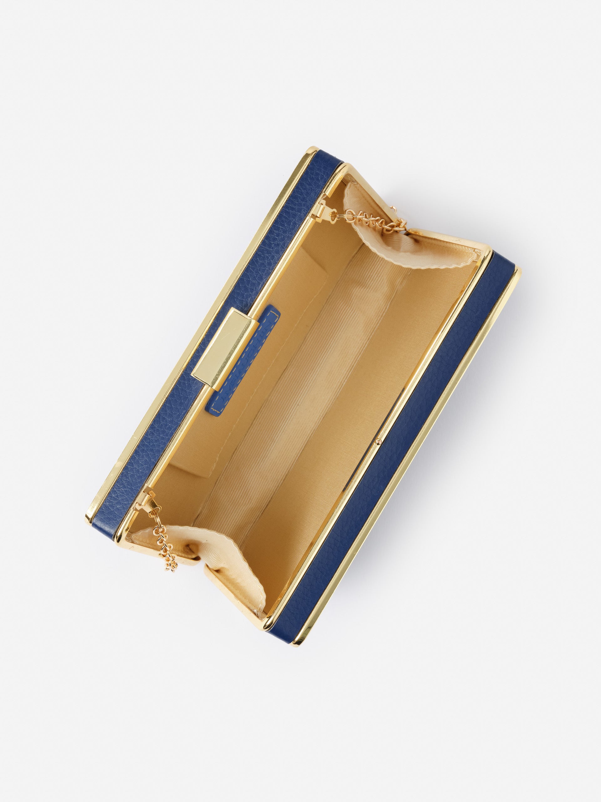 Open navy and gold Audra Acrylic Clutch by J.McLaughlin showcasing its sleek interior with a delicate chain and elegant craftsmanship, embodying effortlessly stylish, enduring designs.