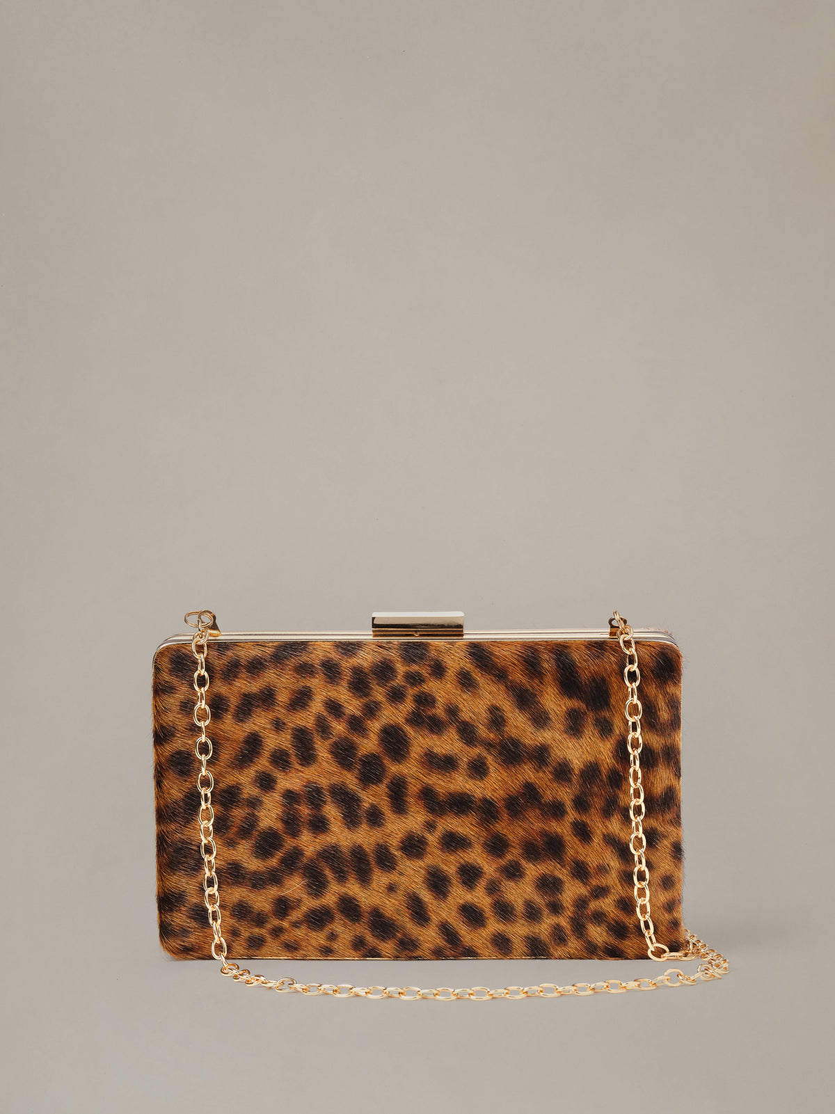 The Palm Pony Hair Clutch in Leopard by J.McLaughlin featuring leopard print pony hair and a gold chain strap a timeless statement bag for polished style