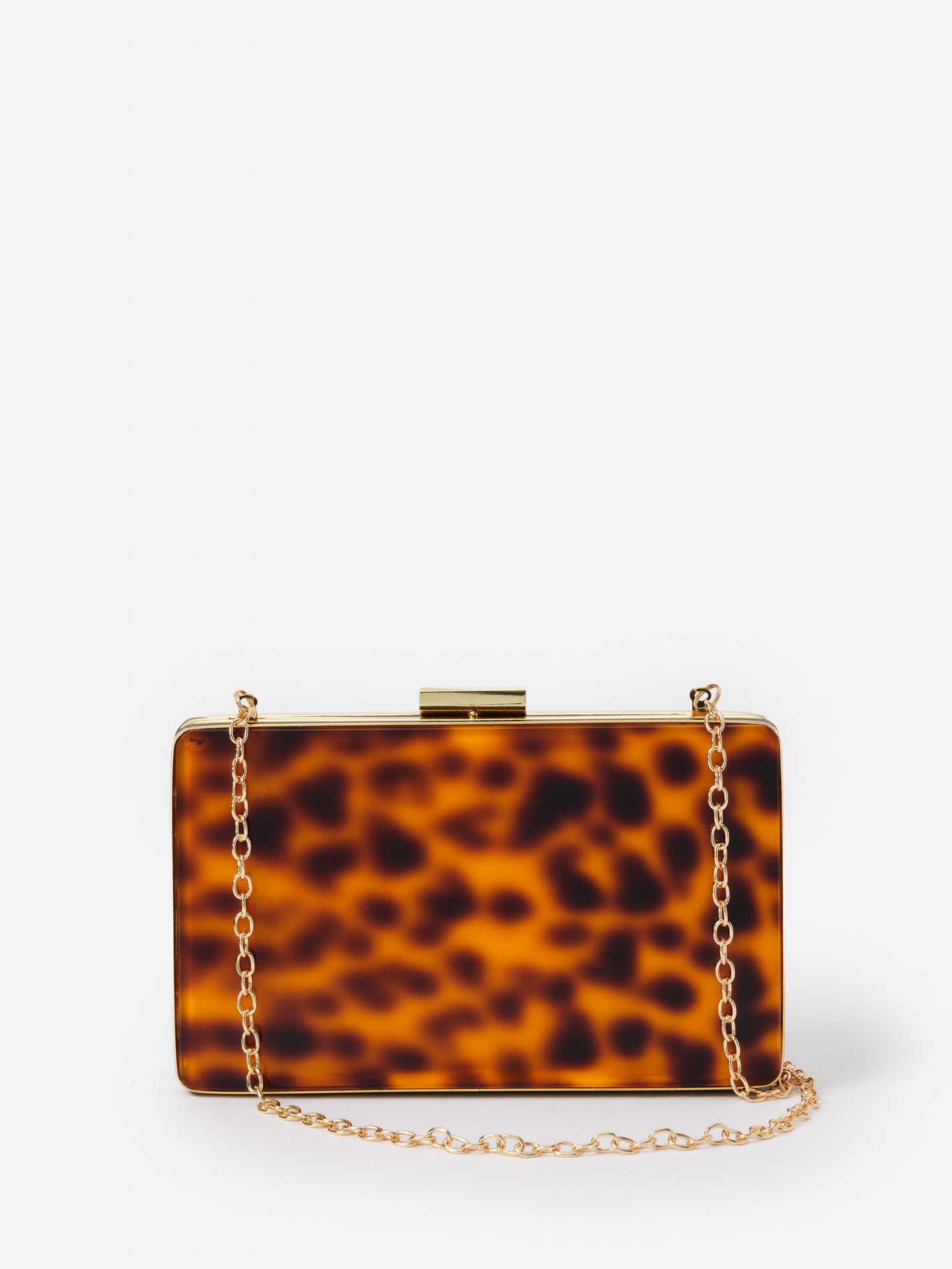 Audra Acrylic Clutch in Tortoise by J.McLaughlin features effortlessly stylish design with a tortoise pattern and gold chain, embodying enduring designs and a legacy of timeless fashion. A destination for defining style. Life, Well-Lived.