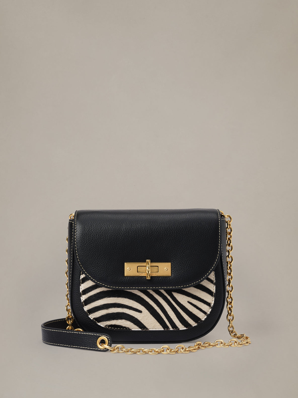 The Waverly Leather Handbag in Zebra Stripes by J.McLaughlin with black leather zebra stripe panel and gold chain strap for versatile everyday style