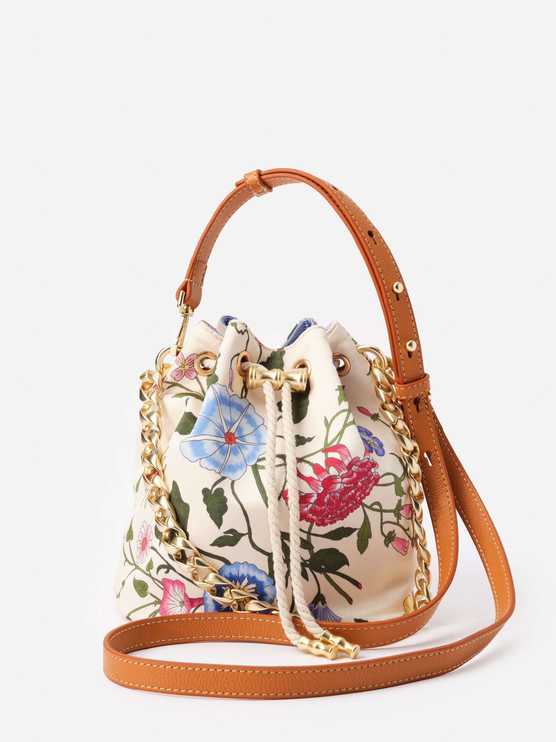 Sarah Bucket Bag in Dragonfly Garden featuring a floral design with gold chain and tan leather strap by J.McLaughlin, showcasing effortlessly stylish, enduring designs.
