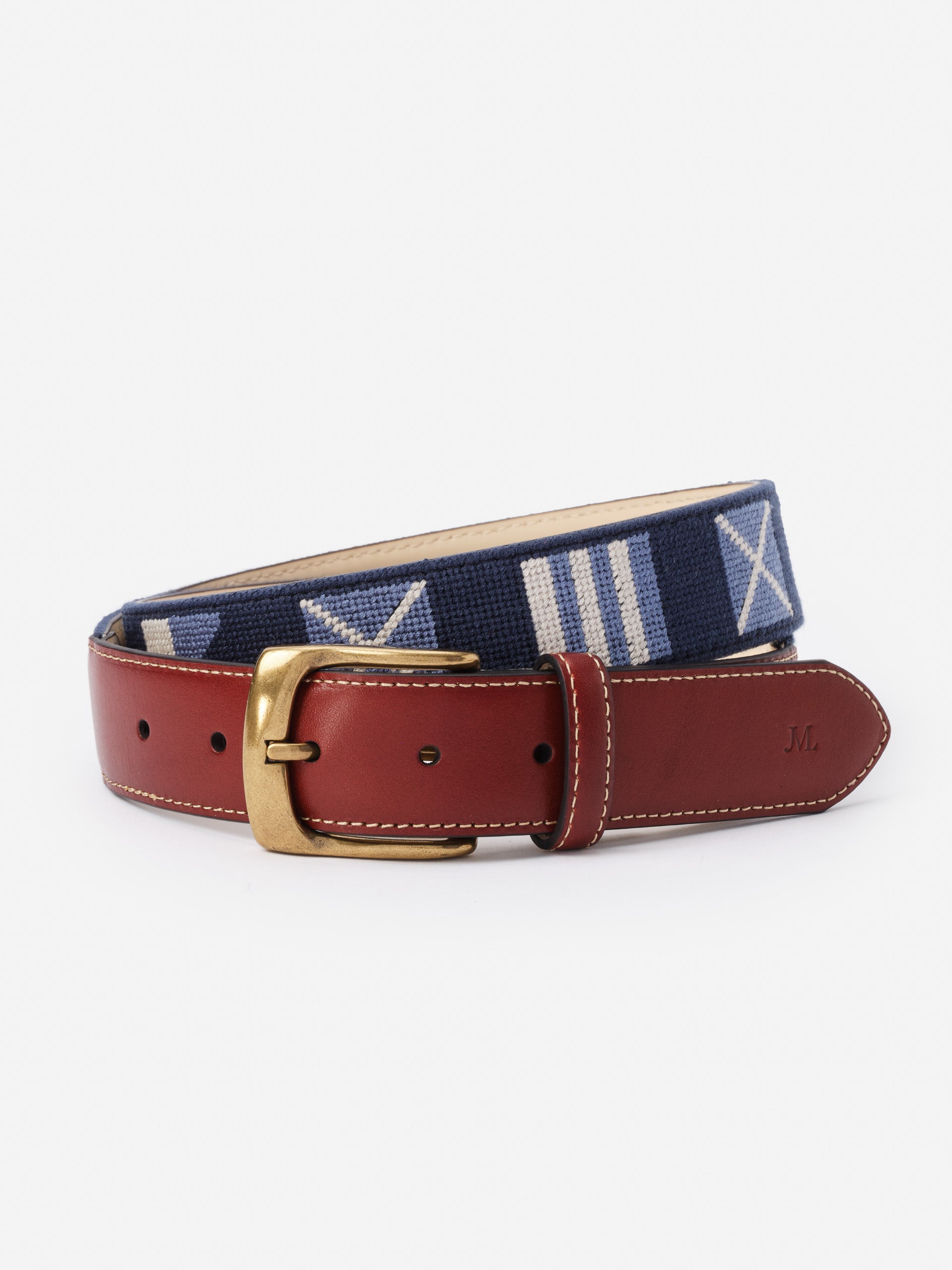 Needlepoint Belt in Nautical Flag by J.McLaughlin features a classic navy needlepoint design with nautical flags, complemented by rich leather and a brass buckle, embodying effortlessly stylish, enduring designs from a destination for defining style. Life, Well-Lived.