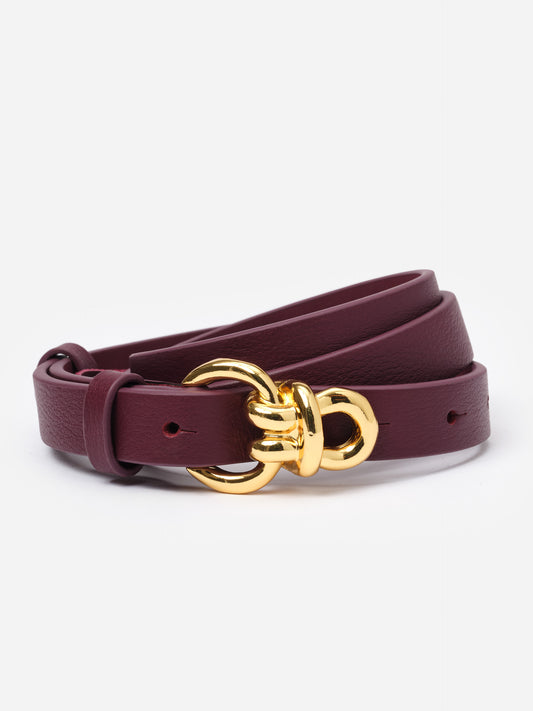 Natalie Leather Belt in deep burgundy with signature gold knot hardware by J.McLaughlin, offering an effortlessly stylish accessory for dresses and jeans.