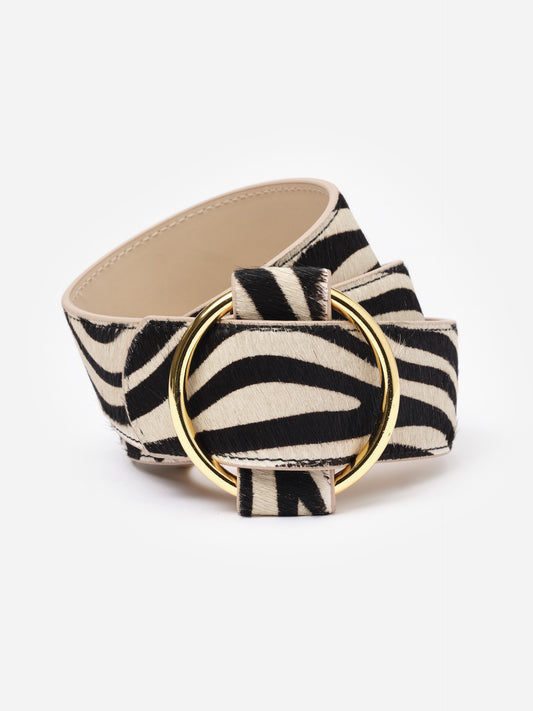 Amelia Pony Hair Belt in Zebra Stripes by J.McLaughlin featuring a bold zebra print pattern with a smooth, wide silhouette and a polished gold metal ring buckle for stylish layering over sweaters or jackets.