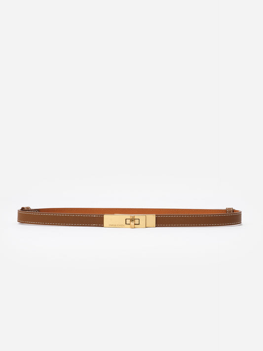 Liv Leather Belt by J.McLaughlin, featuring pebble grain leather and a polished gold turn-lock buckle, an effortlessly stylish accessory for jeans or dresses.
