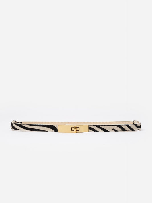 Liv Pony Hair Belt in Zebra Stripes by J.McLaughlin, featuring a sleek zebra pattern with a polished gold turn-lock buckle, perfect for pairing with jeans or dresses.