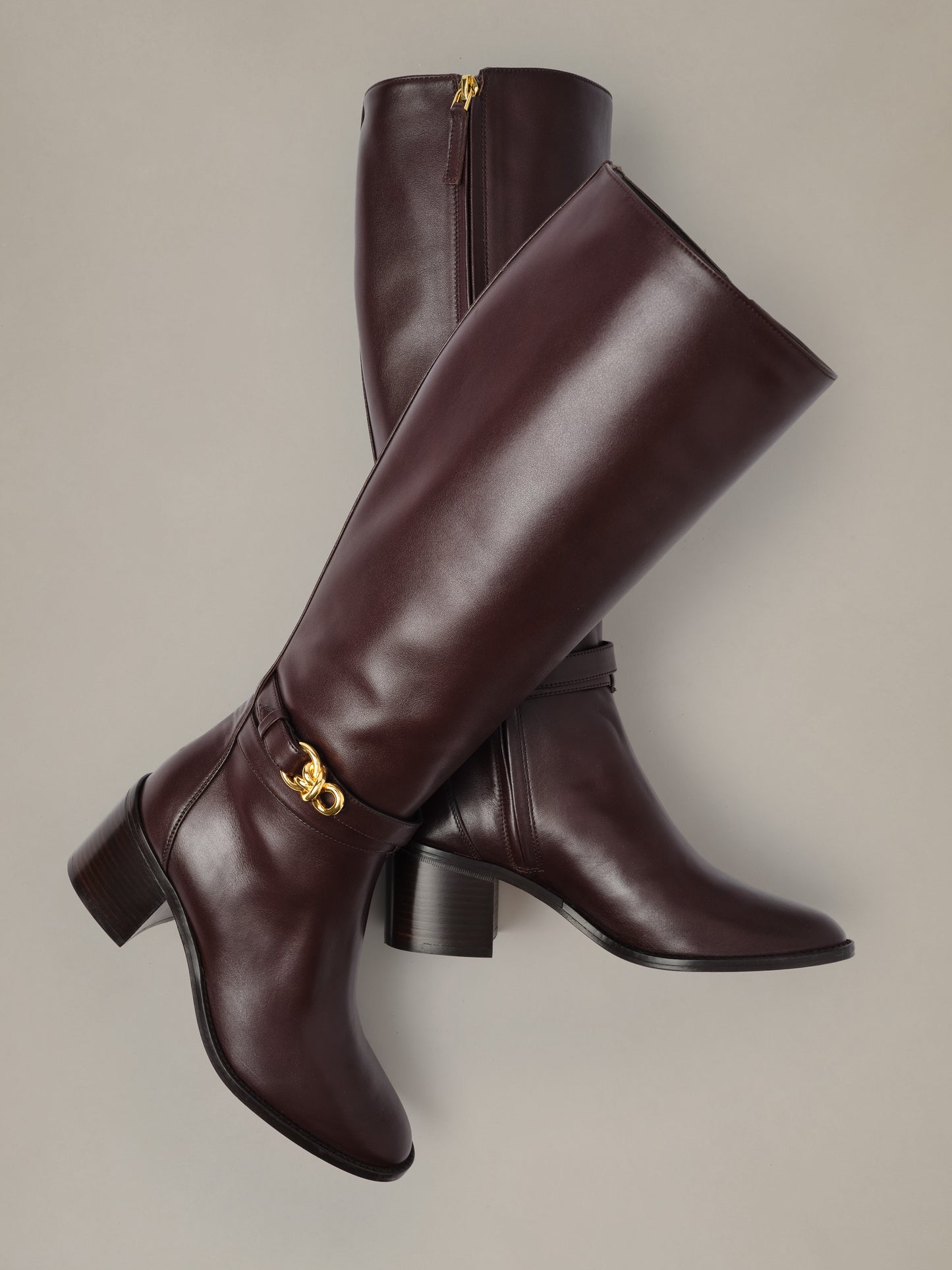 Addison Leather Boots by J.McLaughlin in rich burgundy leather with knee-high shafts stacked block heels and signature gold bamboo zipper pulls